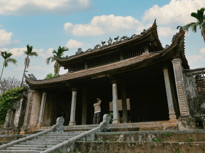 Mặt tiền từ đường: mái ngói rêu phong, đầu đao chạm rồng, hàng cột đá và bậc thềm